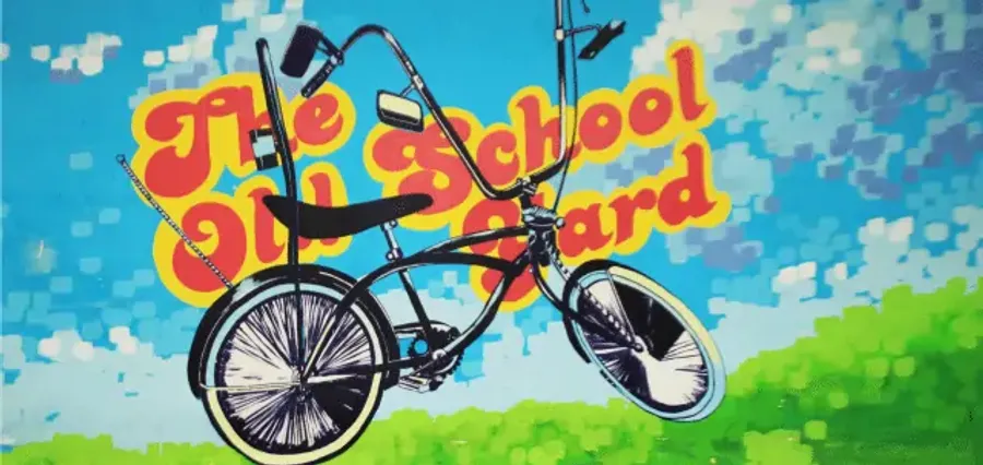 The Old School Yard mural: a chopper bike over the painted sign