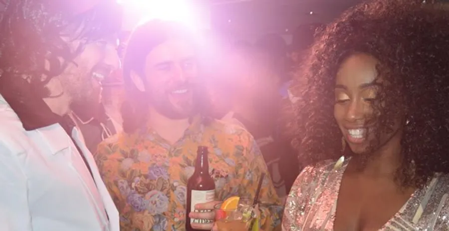 Friends laughing with drinks on a night out at The Old School Yard